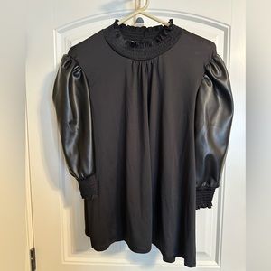 Black, puffy, leather sleeves, mixed material. High quality t-shirt body. NWT